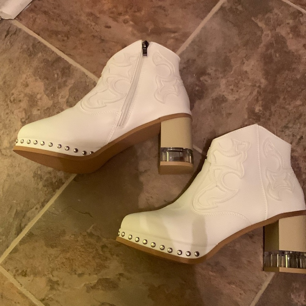 These ivory boots are unique with the studded platform & some clearness on heel